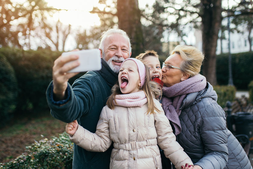 Grandparents with grandchildren taking a photo of themselves