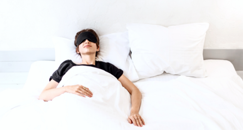 Person sleeping with a sleep mask