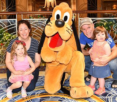 Ashley and her family posing with Pluto the dog.