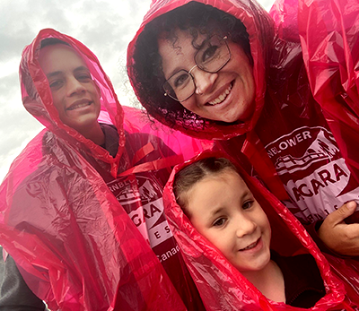 Karley and her two children in red ponchos at Niagara Falls.