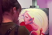 Artist painting at an Art Battle. She is painting an abstract woman with billowing white hair.
