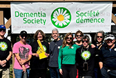 Thumbnail of a group standing in front of the Dementia Society banner.