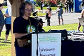 Speaker welcoming guests to a Dementia Society outdoor event.