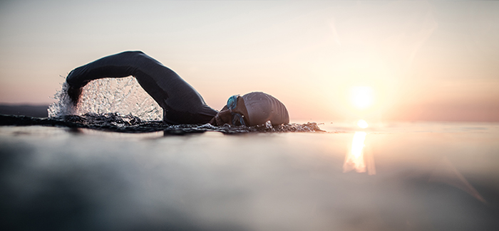 Swimming by a sunrise
